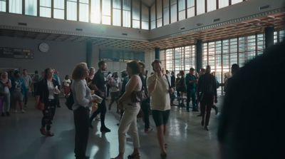 a group of people standing in a large room