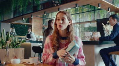 a woman sitting at a table in a restaurant