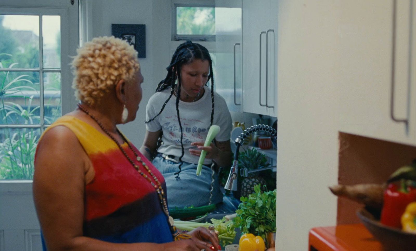 a man and a woman in a kitchen preparing food