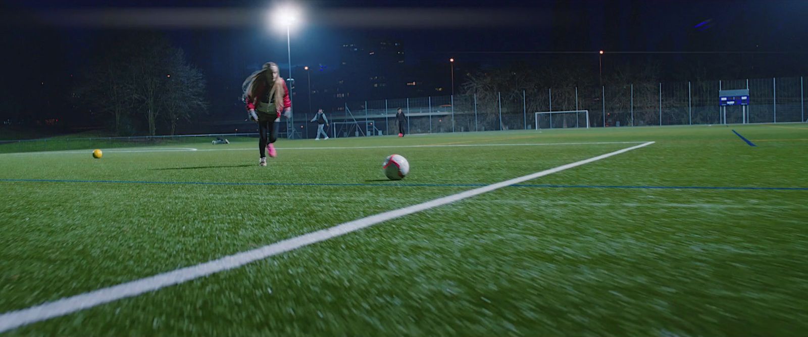 a person standing on a field with a soccer ball