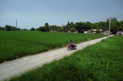 a person riding a motorcycle down a dirt road