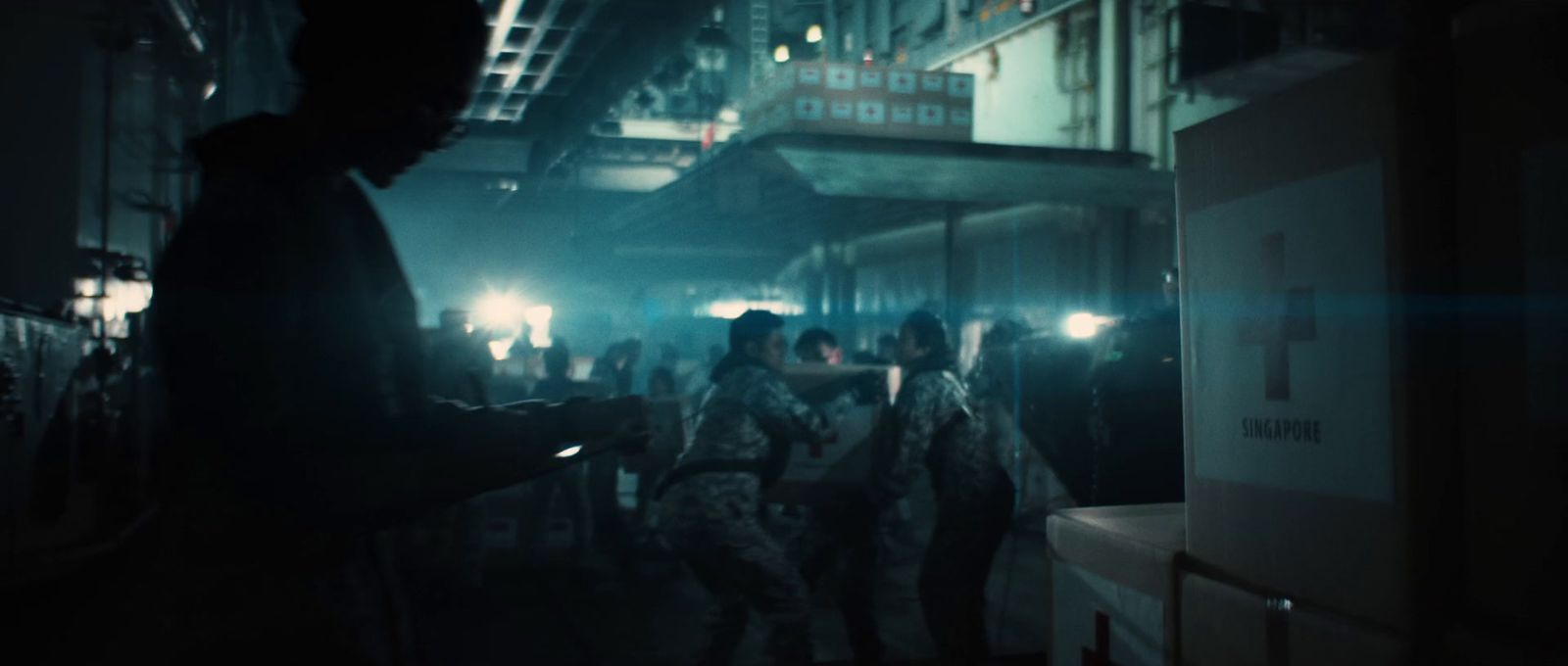 a group of people walking down a street at night