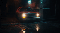 a red truck is parked in a dark alley