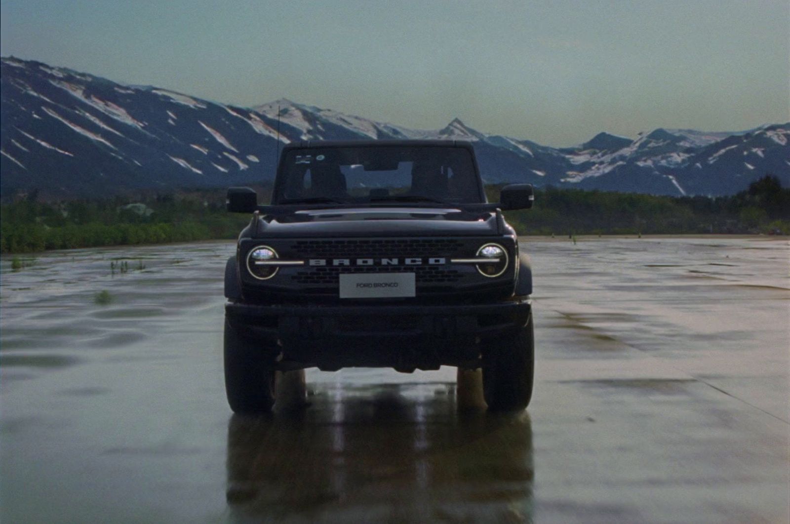 a black jeep is parked in a flooded area