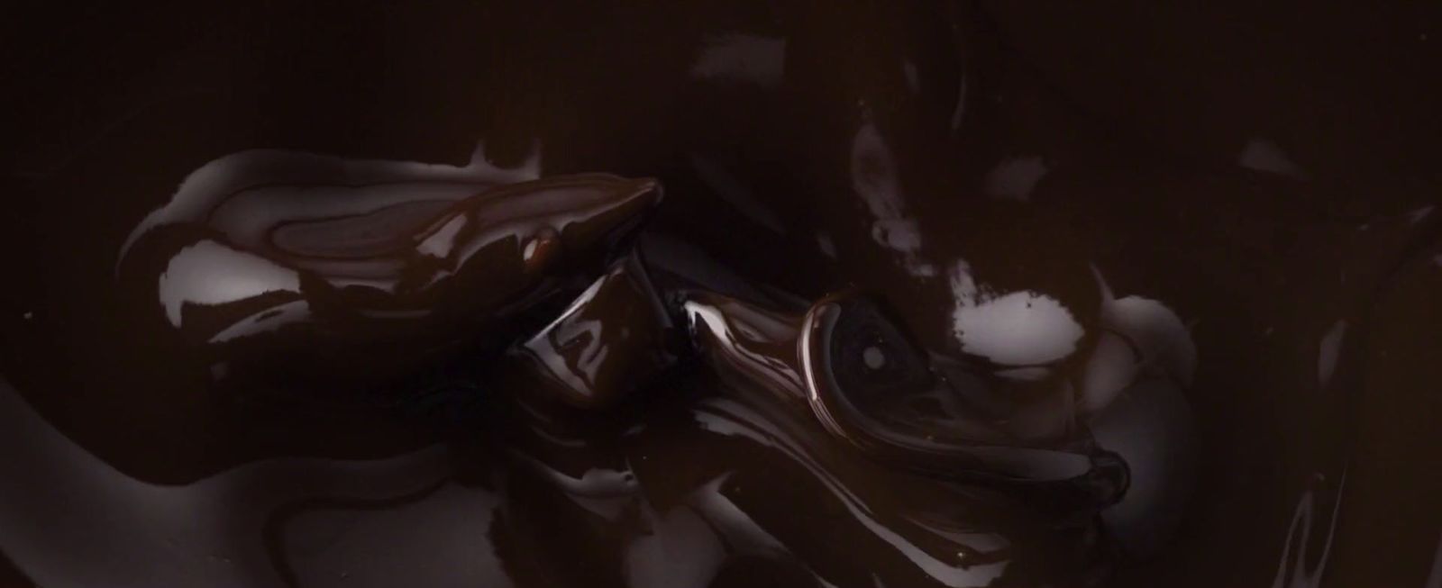 a close up of a chocolate dessert with melted chocolate