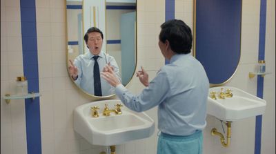 a man standing in front of a mirror in a bathroom