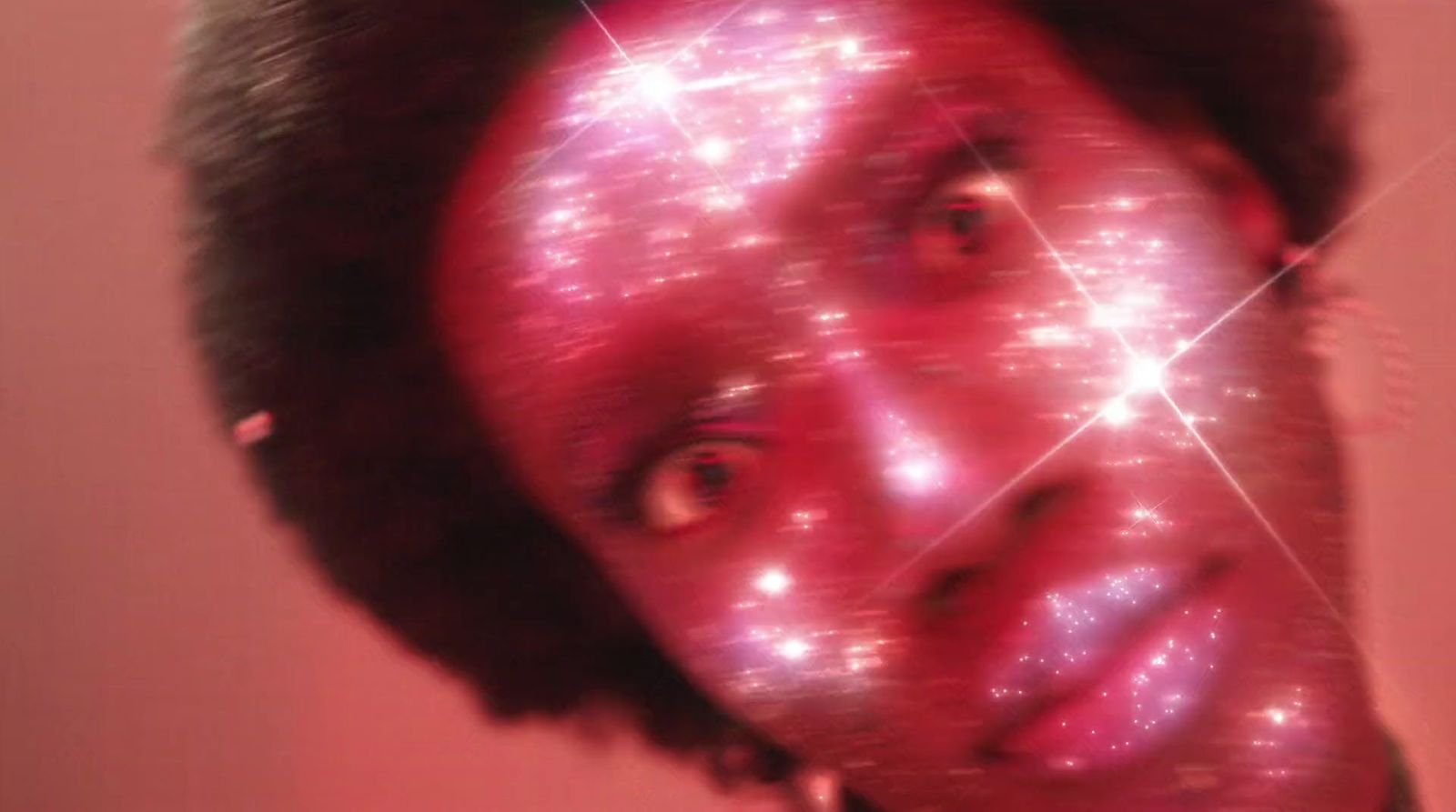 a close up of a person's face with stars in the background