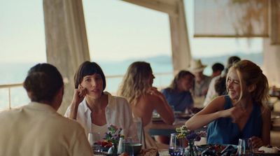 a group of people sitting around a table eating food