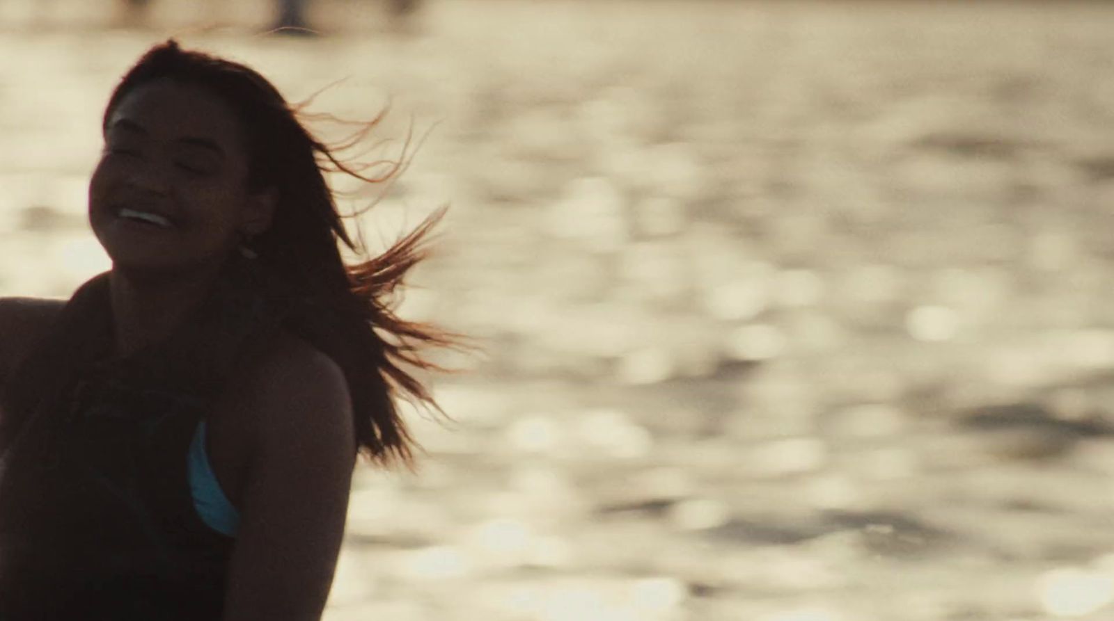 a woman in a bathing suit standing in the water