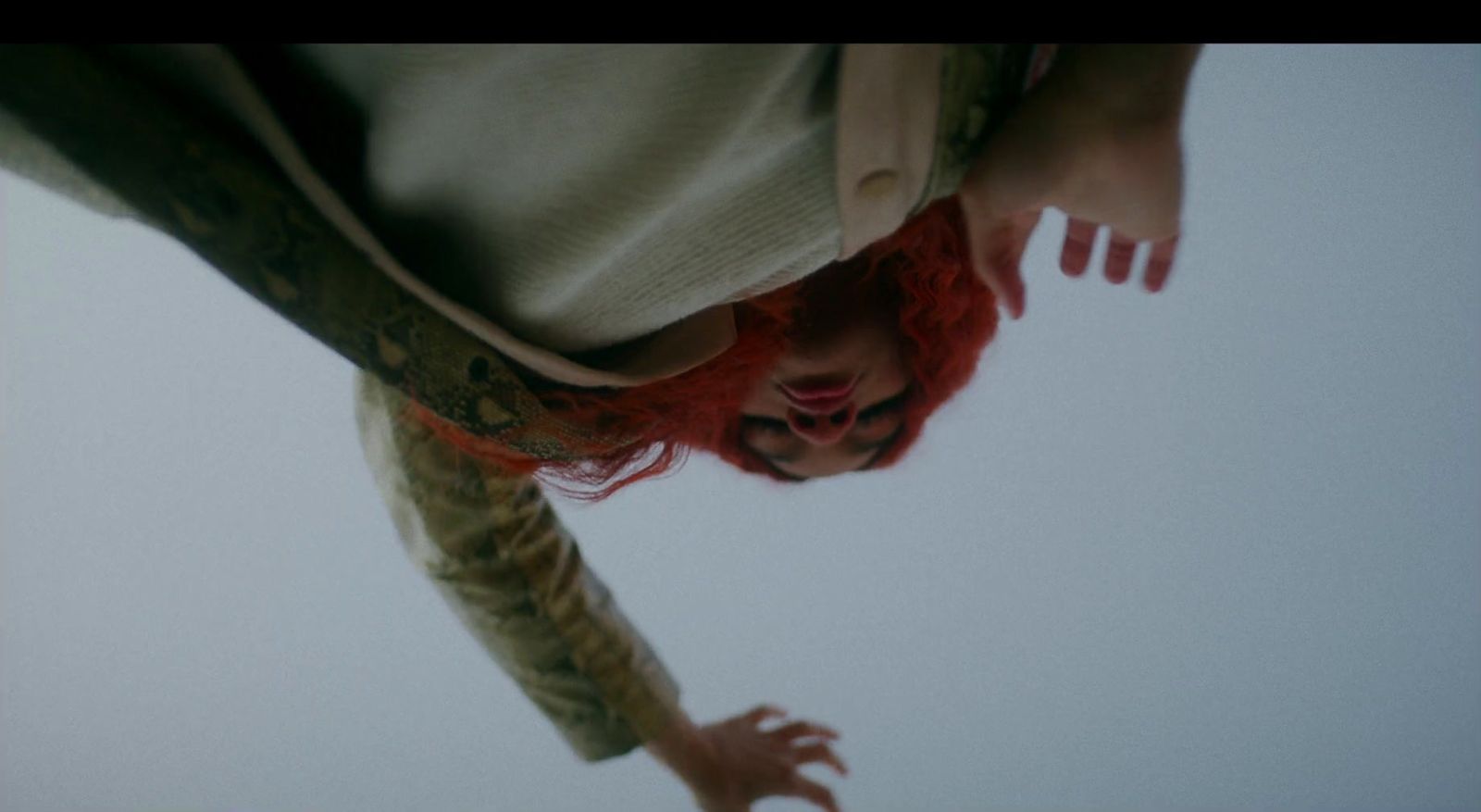 a woman with red hair is upside down