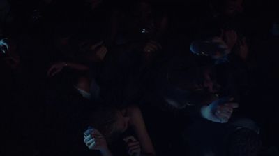 a group of people sitting in a dark room