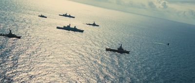 a group of ships floating on top of a large body of water