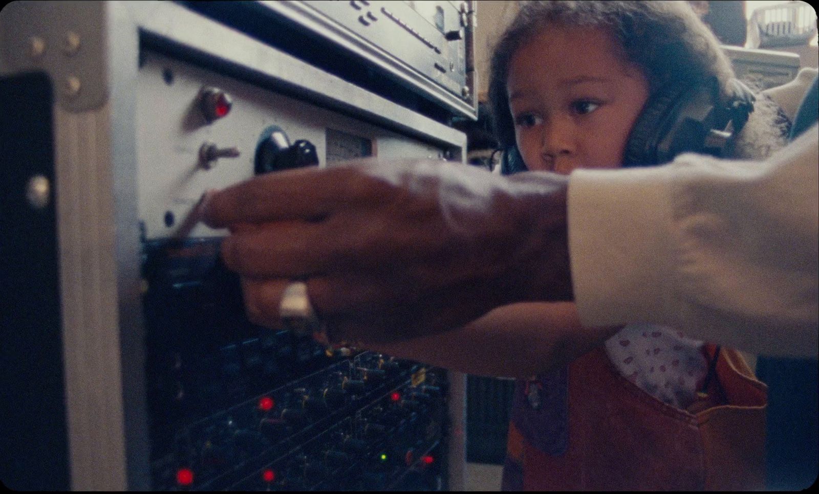 a little girl reaching for something in an oven