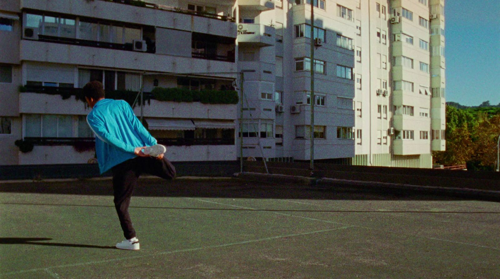 a person on a court with a tennis racket