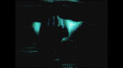 a blurry image of a person's face in the dark