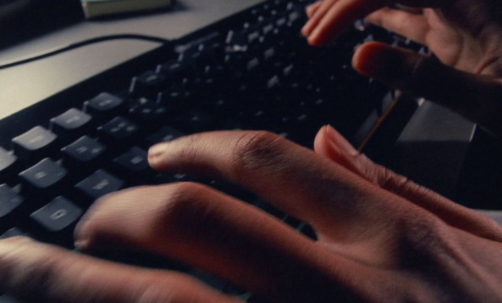 a person typing on a keyboard with their hands