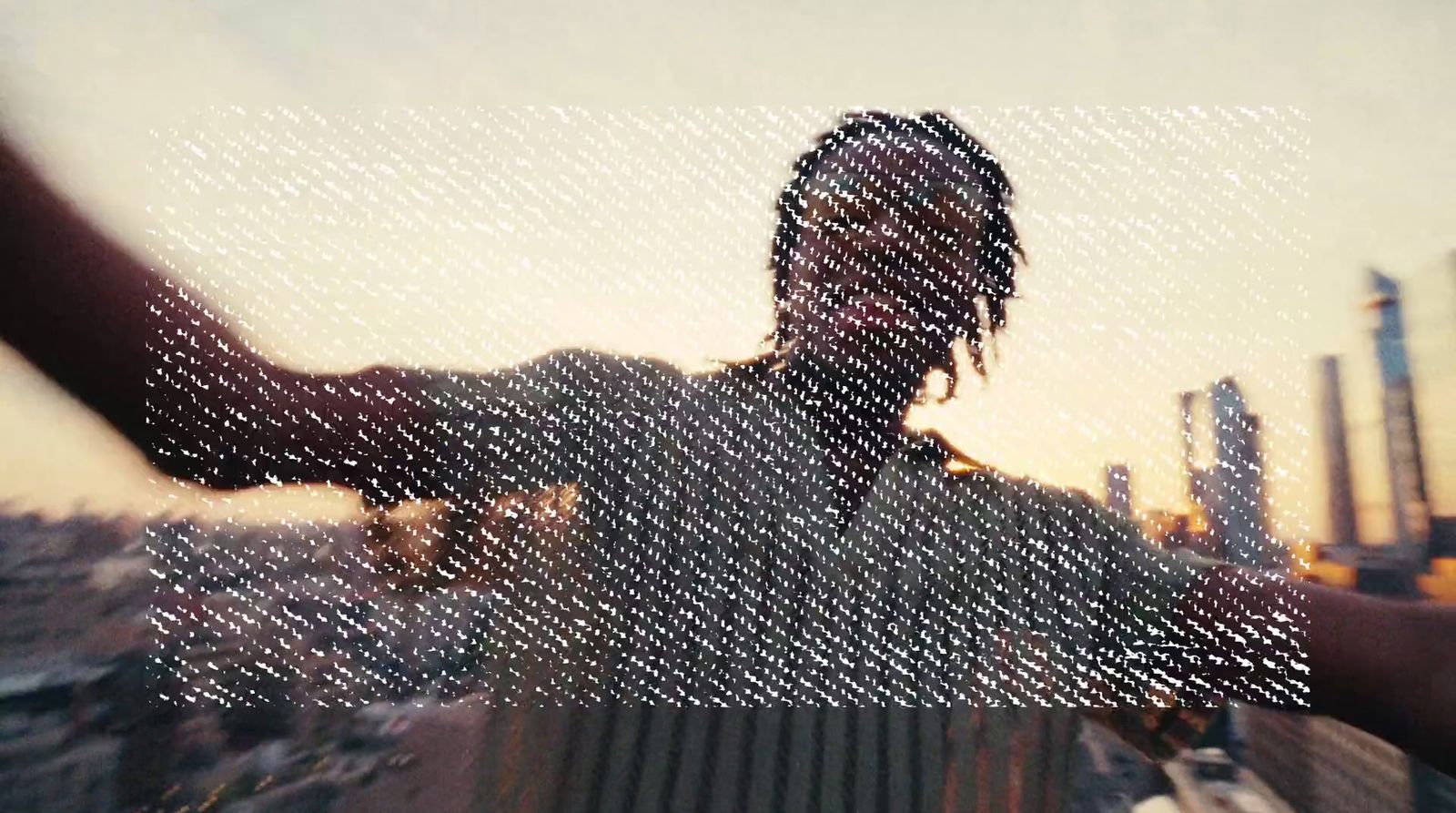 a person with dreadlocks standing in front of a building