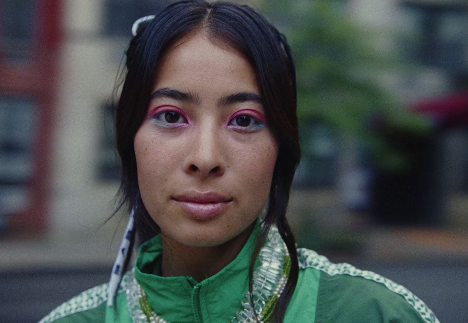 a close up of a person wearing a green shirt