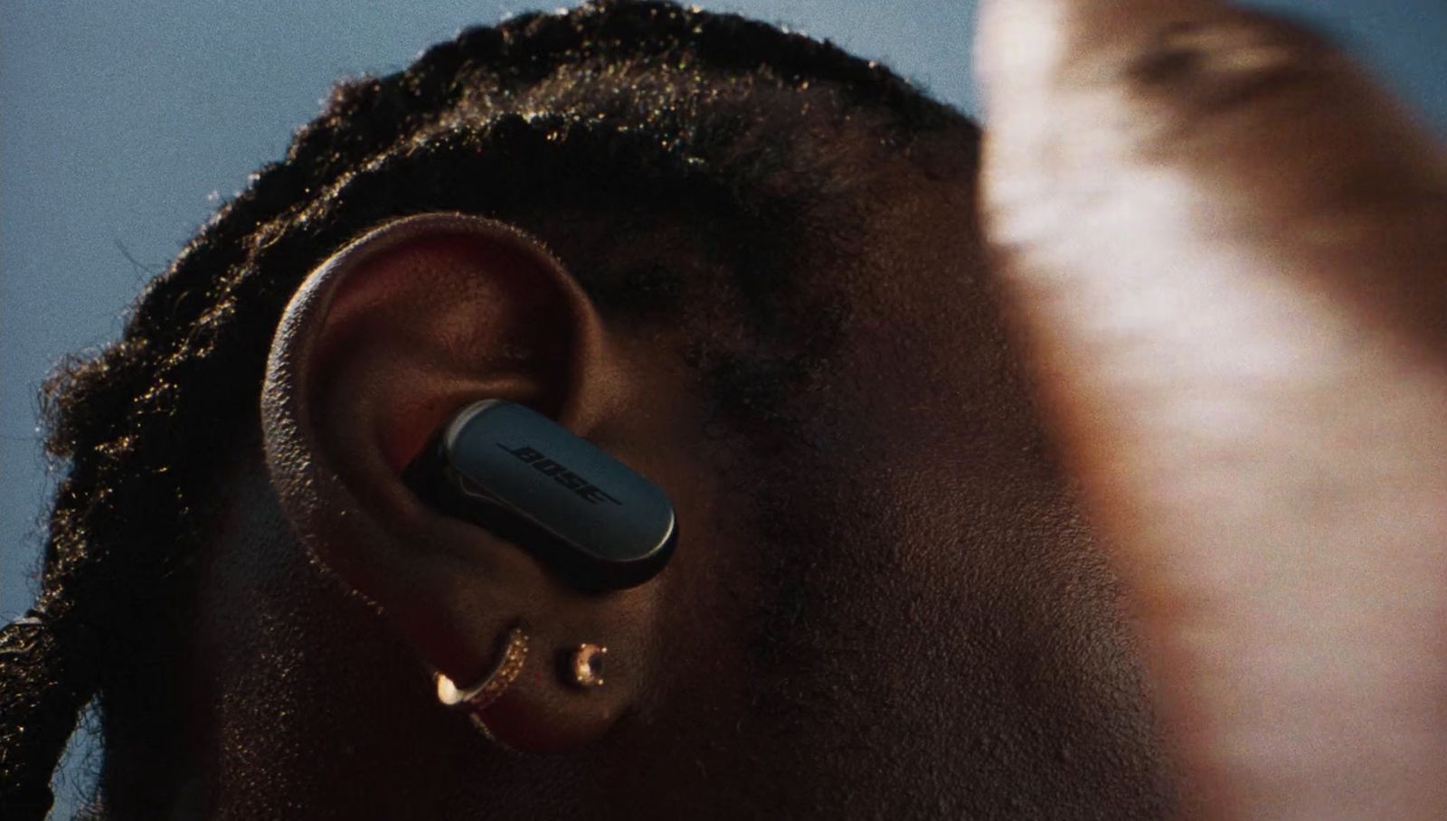 a close up of a person with a pair of ear buds