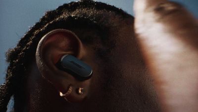 a close up of a person with a pair of ear buds