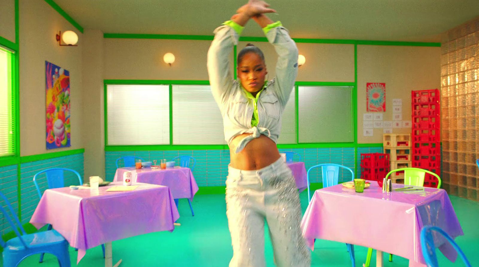 a woman is dancing in a brightly colored room