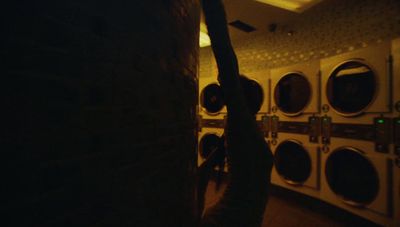 a row of washers in a public laundment