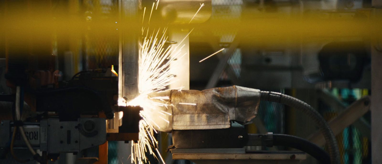 welder working on a piece of metal in a factory