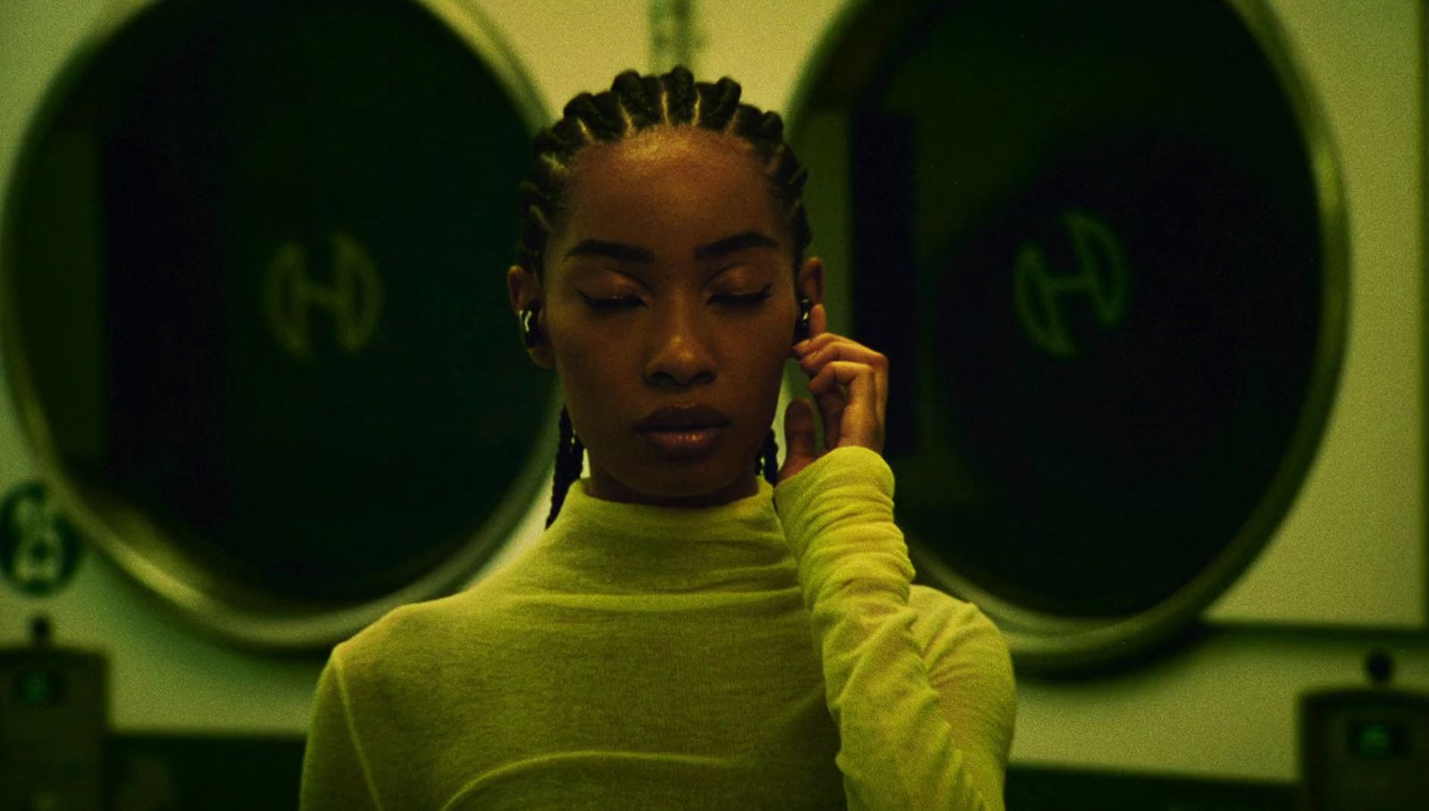 a woman with dreadlocks talking on a cell phone