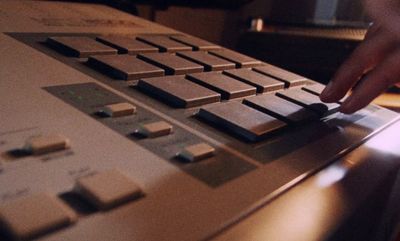 a person pressing buttons on a sound board