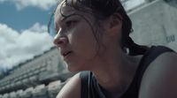 a woman with wet hair standing in front of a building