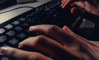 a person typing on a keyboard with their hands