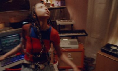 a woman standing in front of a bunch of musical equipment