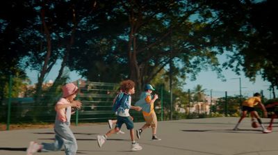 a group of young children playing a game of frisbee