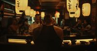 a group of people sitting at a bar