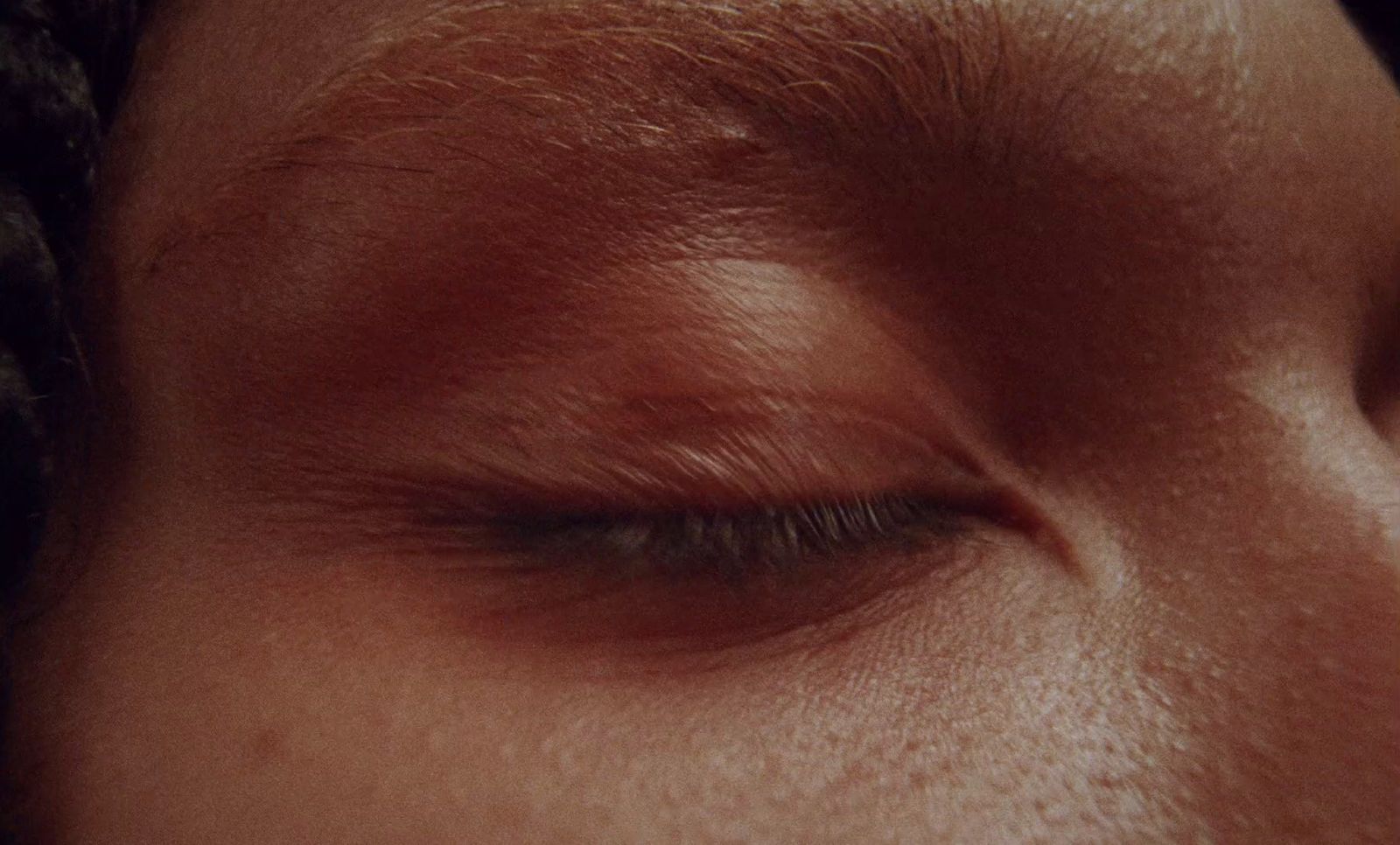 a close up of a person's eye with a blurry background