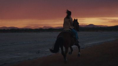 a person riding a horse on a dirt road