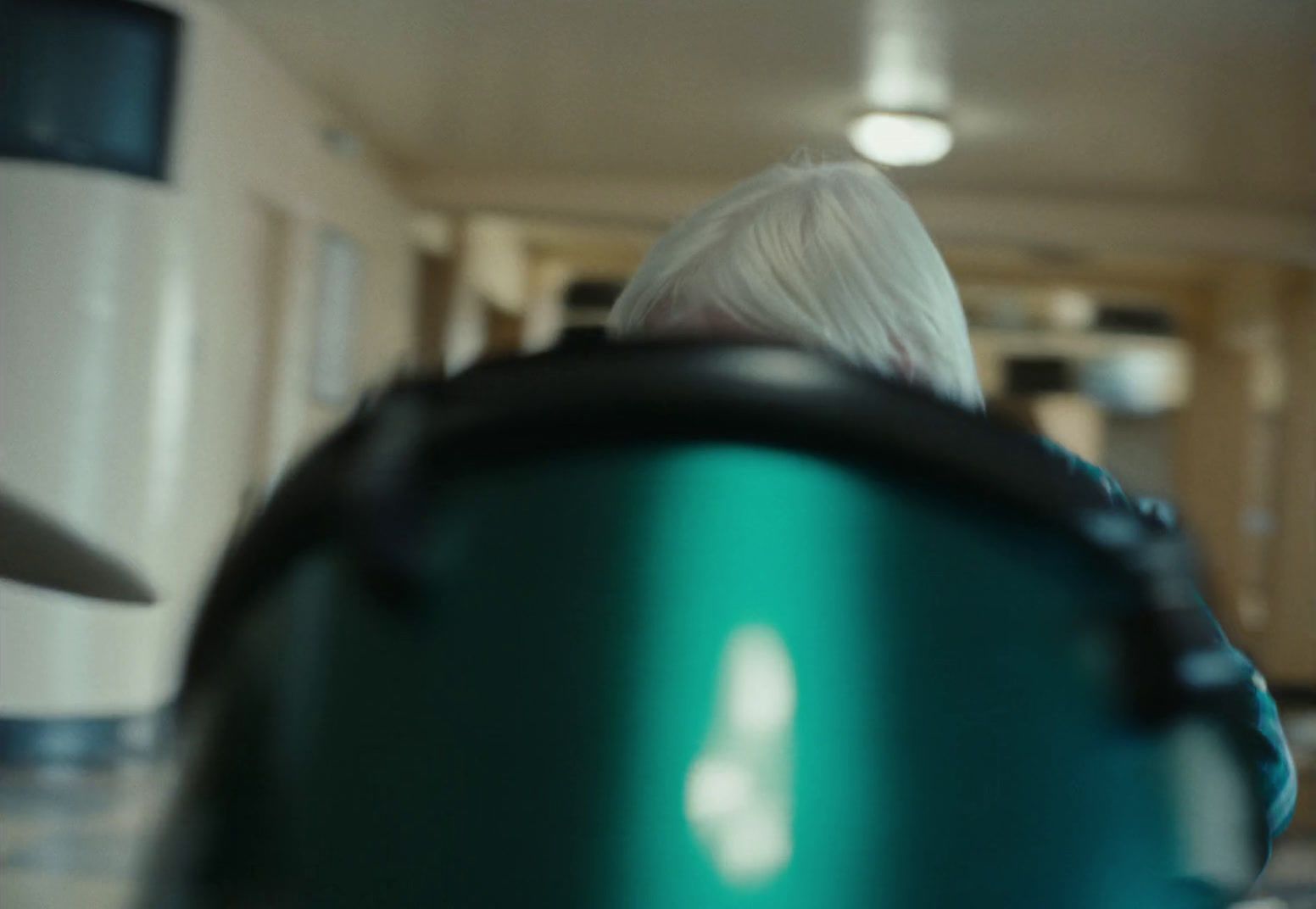 a close up of a person holding a green object