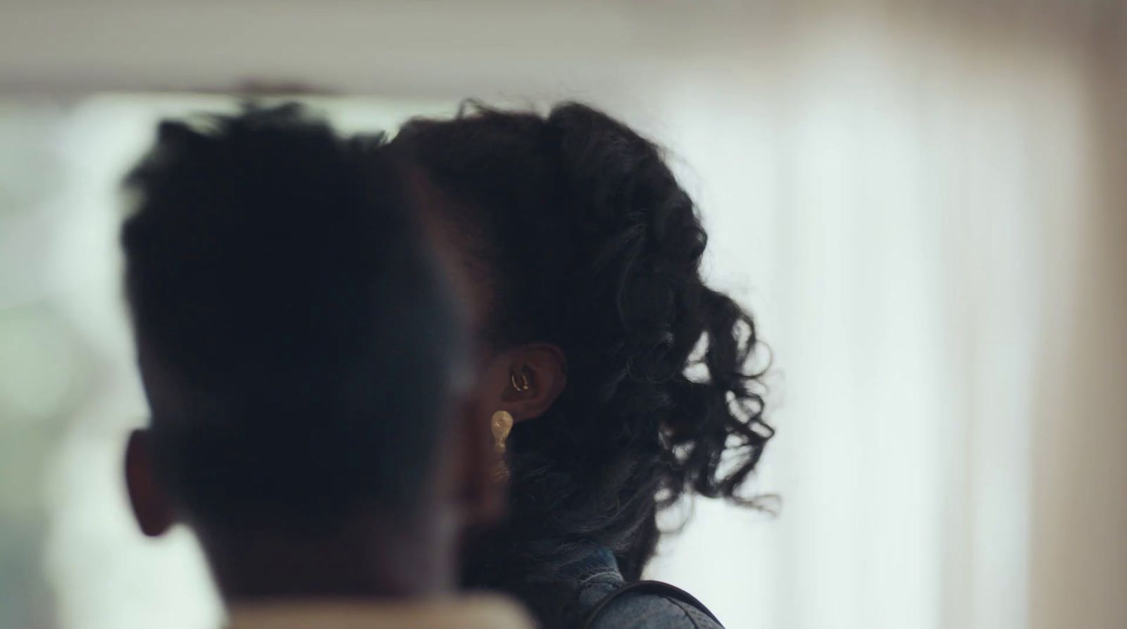 a woman looking at herself in the mirror