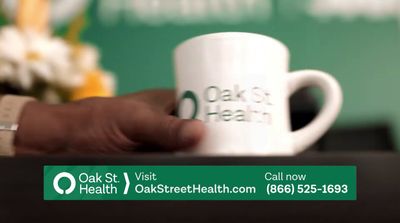 a person holding a coffee cup with the words oak st visit on it