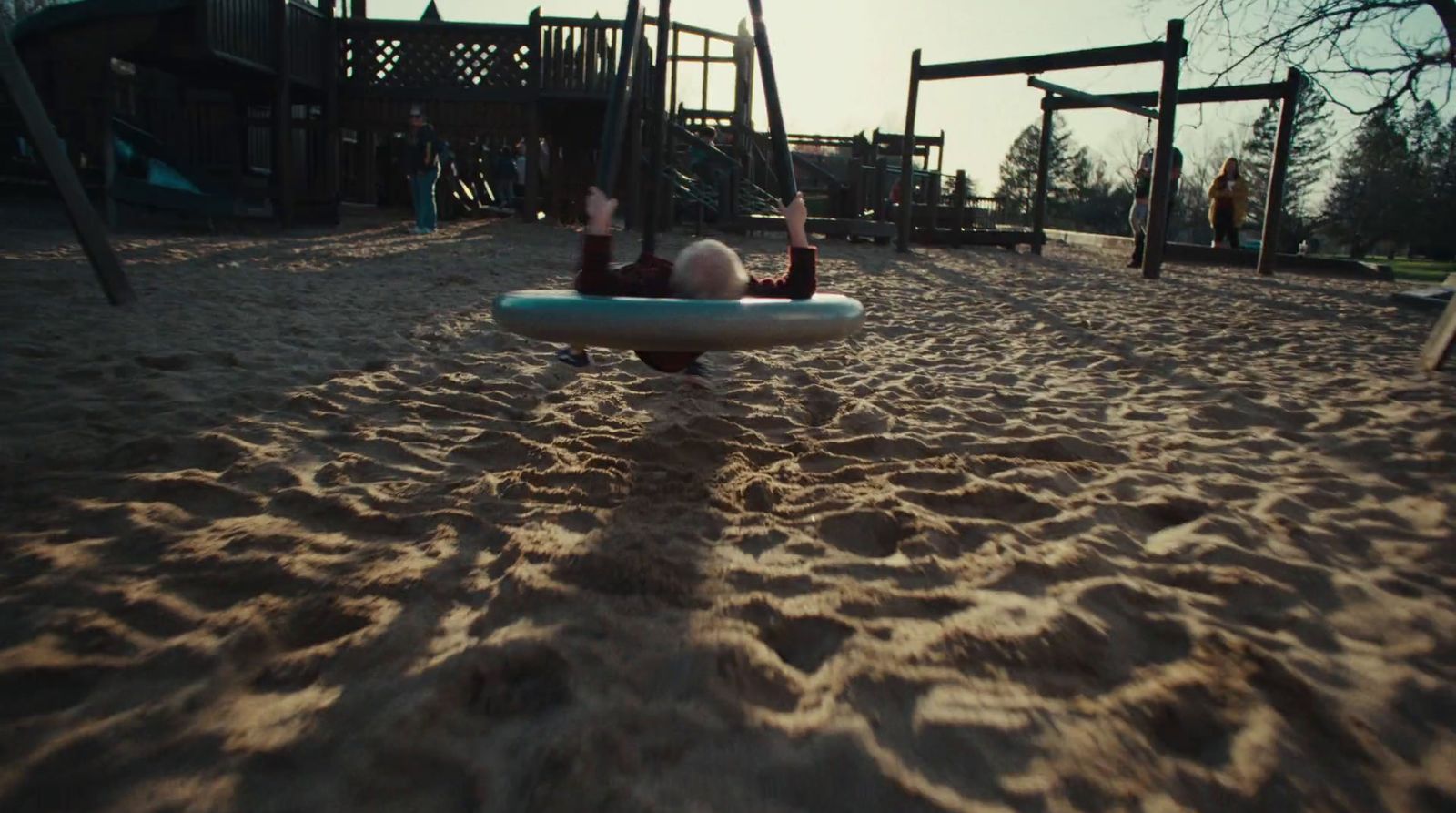 a person laying on a surfboard in the sand