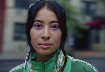 a close up of a person wearing a green shirt