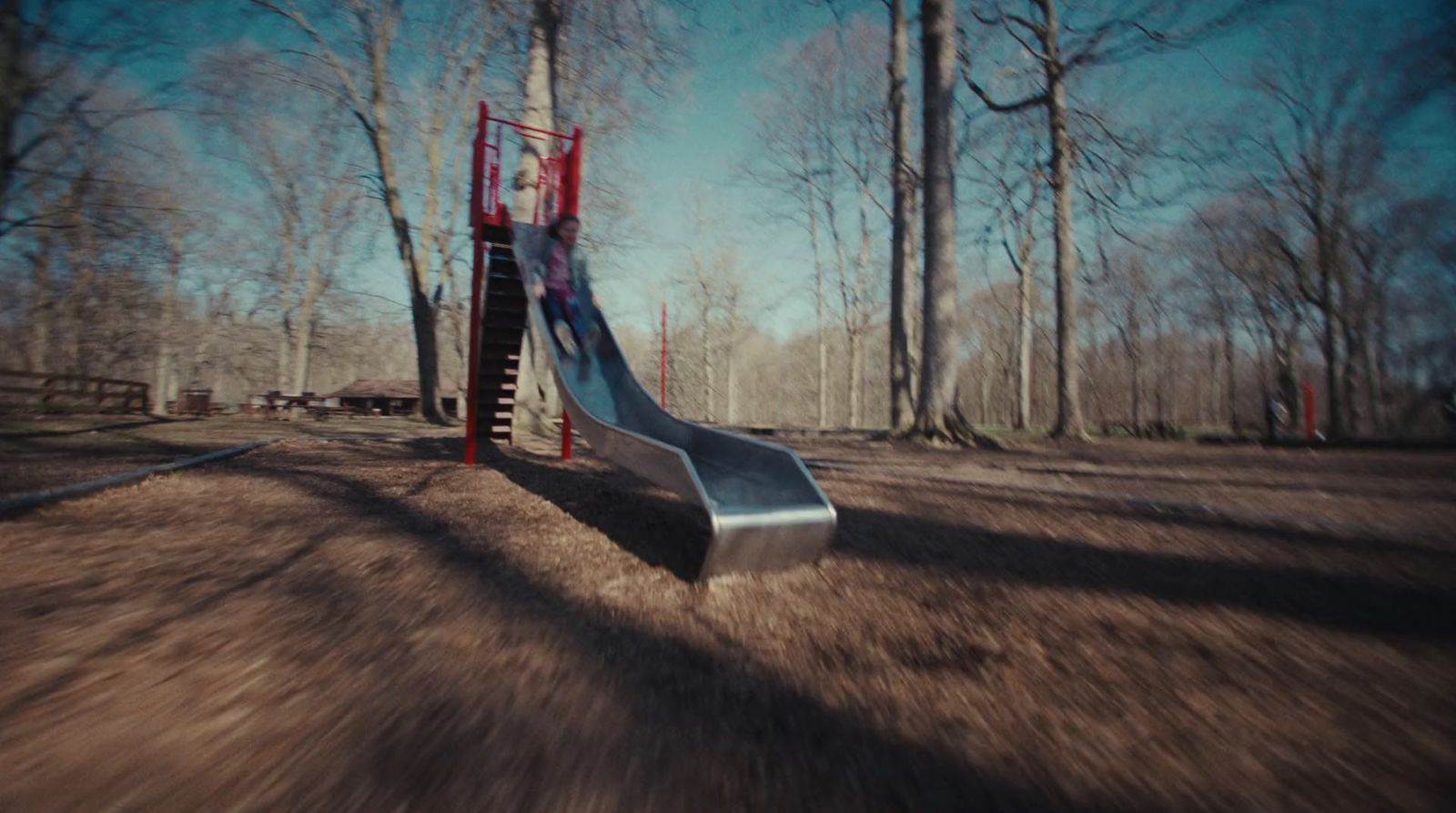 a playground with a slide in the middle of it