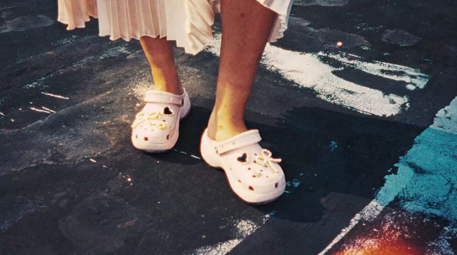 a close up of a person wearing white shoes