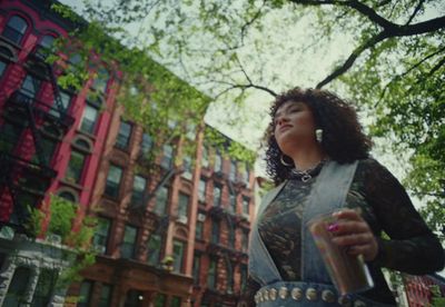 a woman standing in the middle of a city