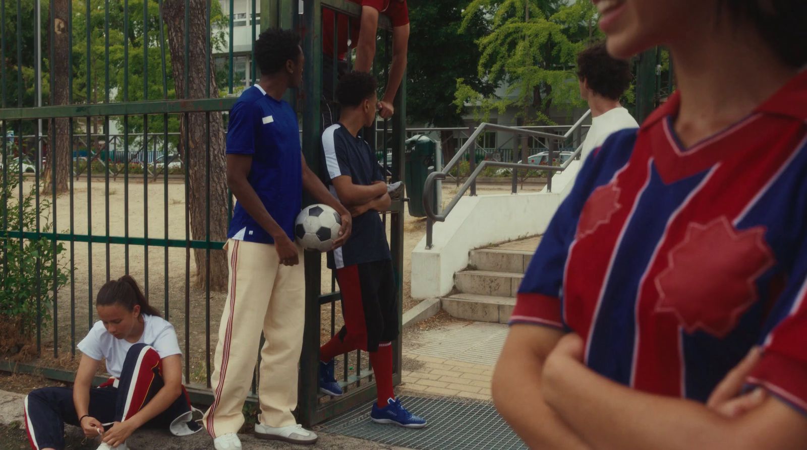 a group of young people standing around a soccer ball