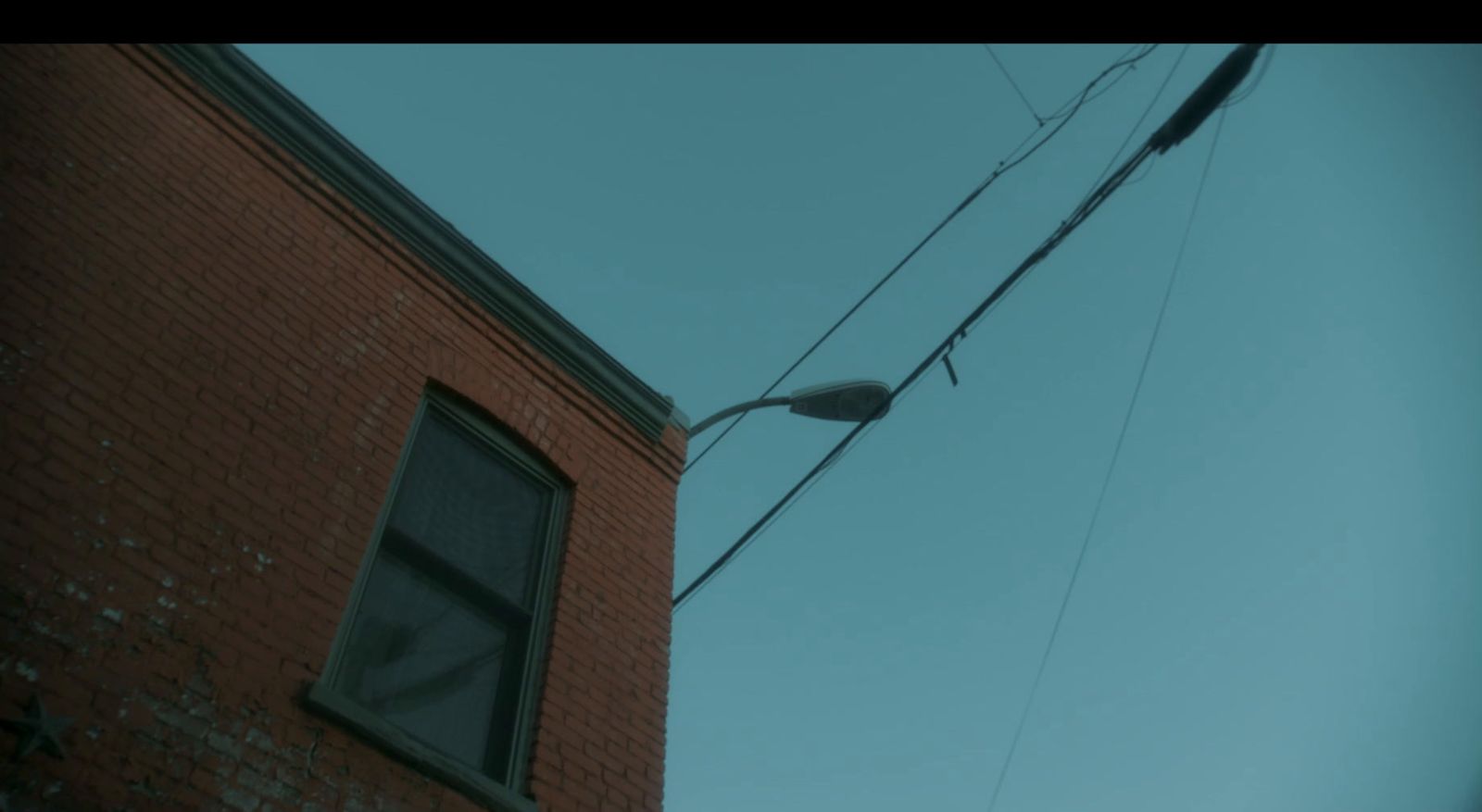 a street light hanging off the side of a building