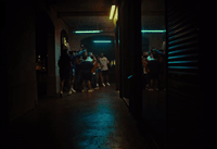 a group of people standing in a dark hallway