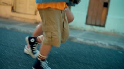 a person walking down a street with a camera