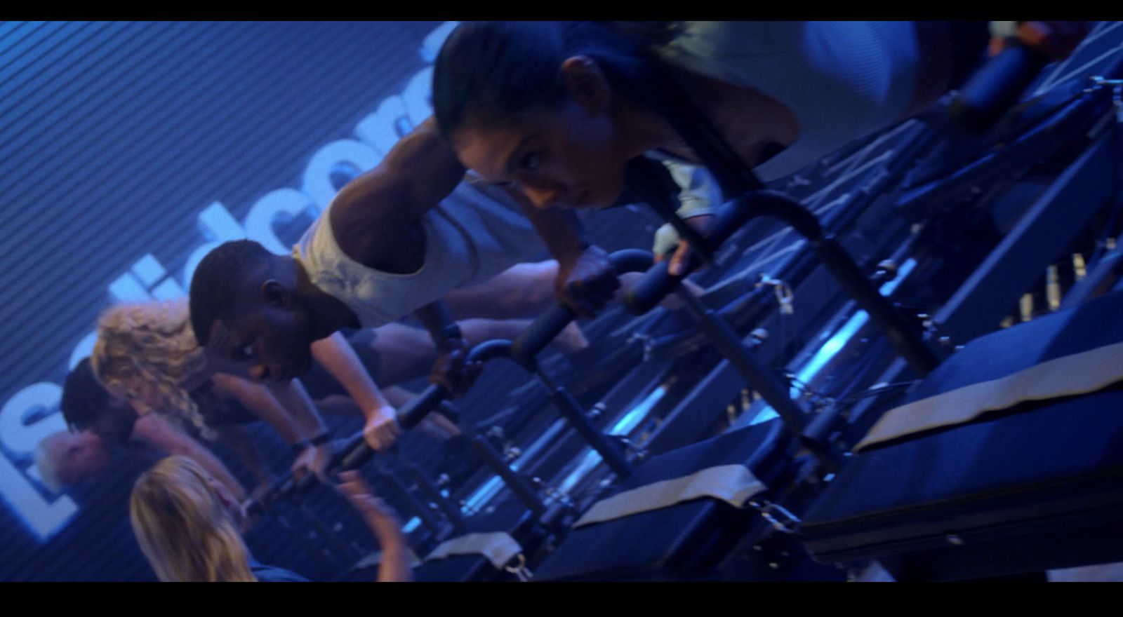 a group of people doing push ups in a gym