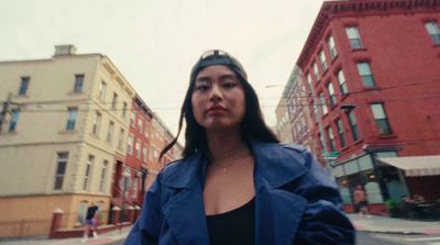 a woman standing in the middle of a street